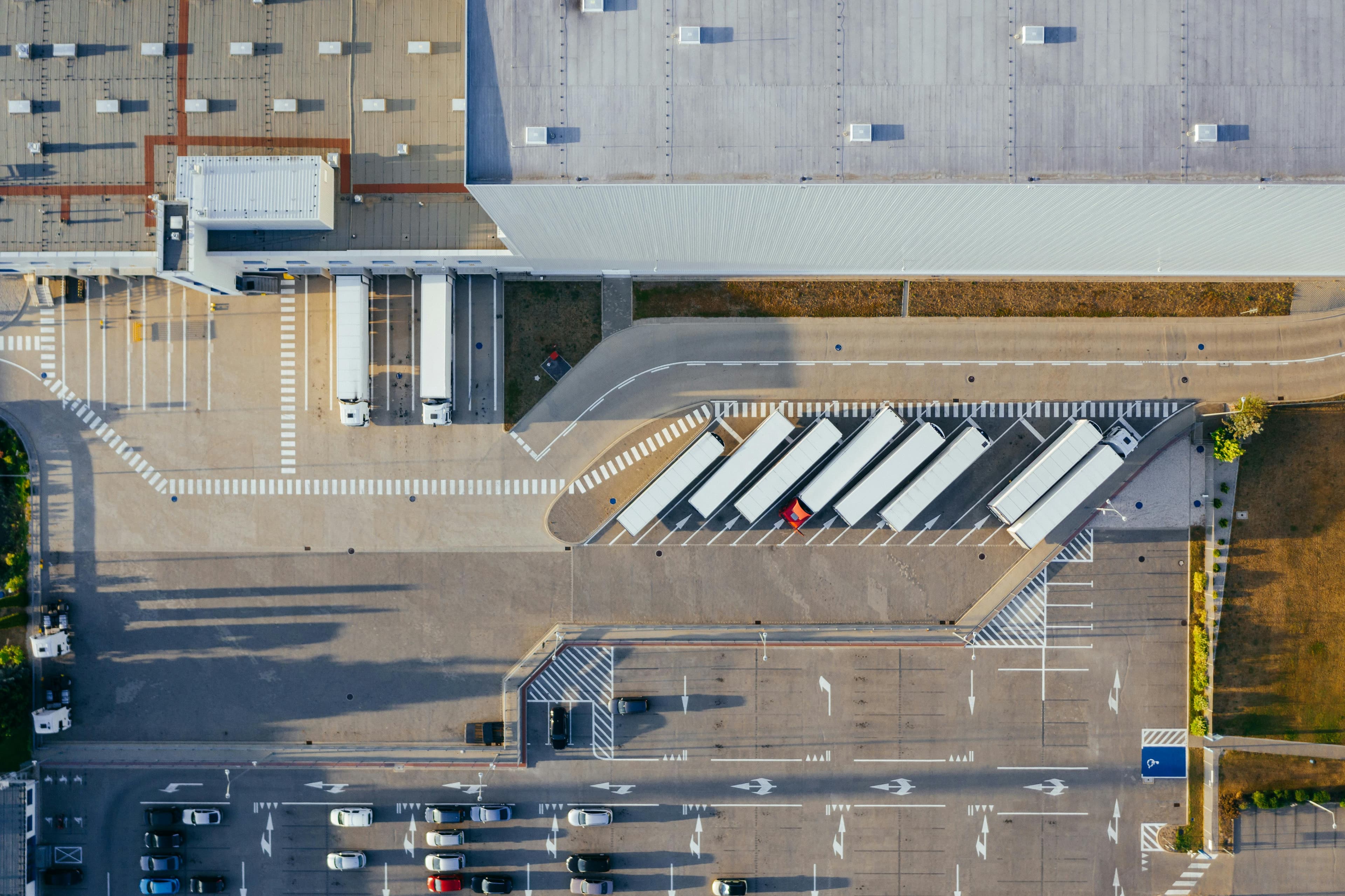 An overhead view of a freight facility with trailers positioned at loading docks